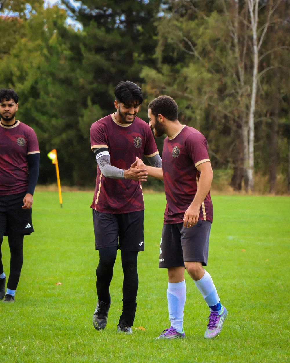 Spartans teammates sharing a moment on the pitch