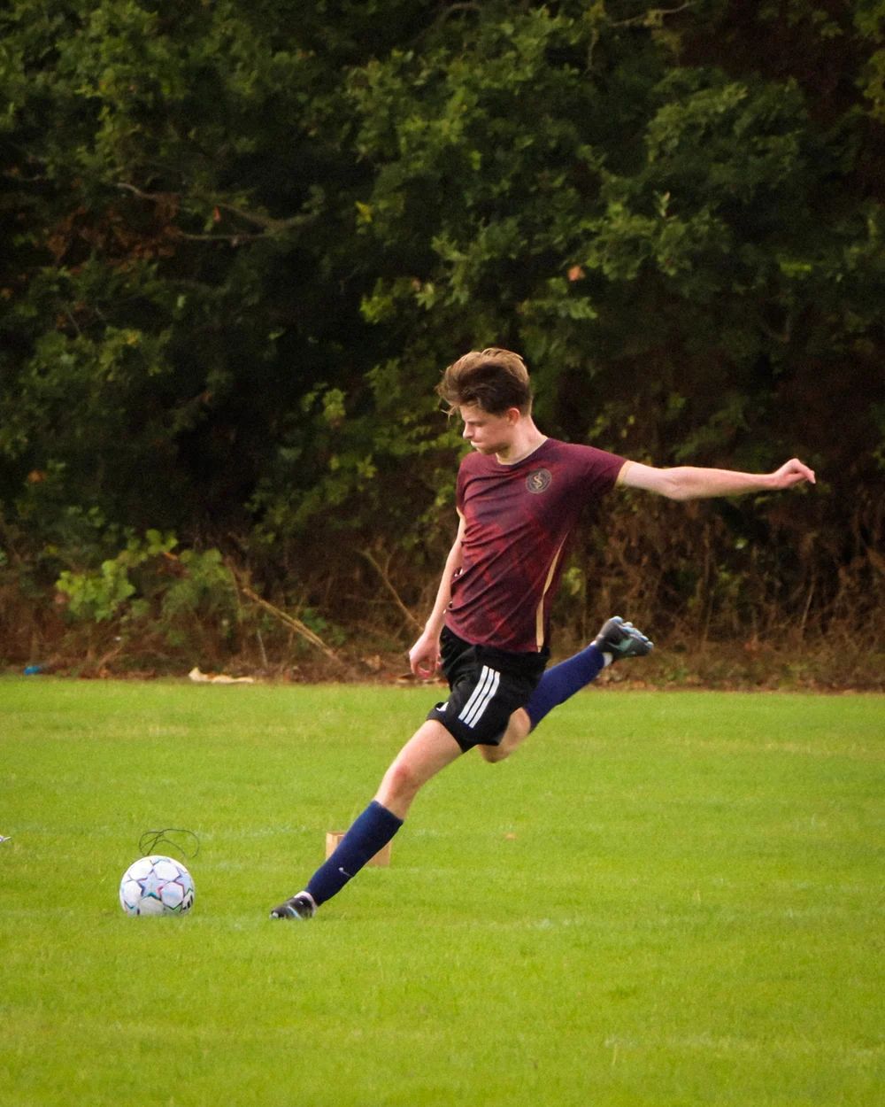 A Spartans player striking the ball during a match